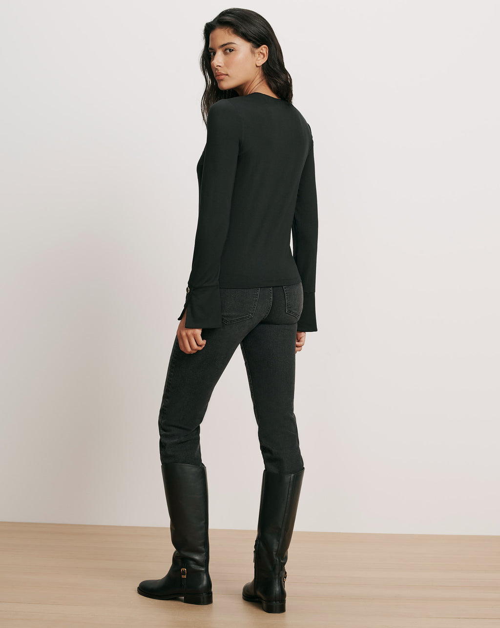 Veronica Beard Black long-sleeve top and black jeans.