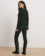 Veronica Beard Black long-sleeve top and black jeans.
