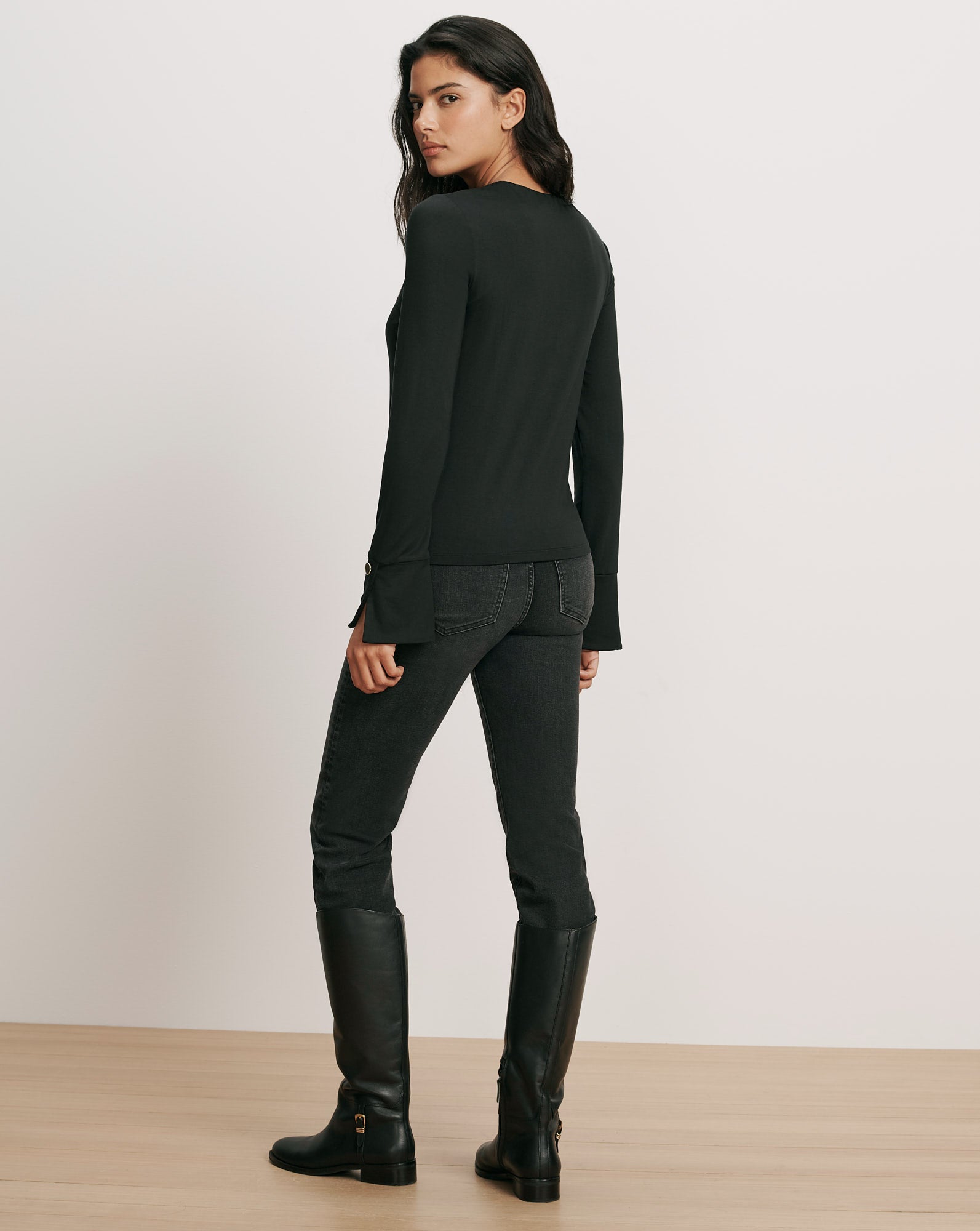 Veronica Beard Black long-sleeve top and black jeans.