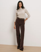 Veronica Beard Beige ribbed turtleneck, brown corduroy pants, studded belt.