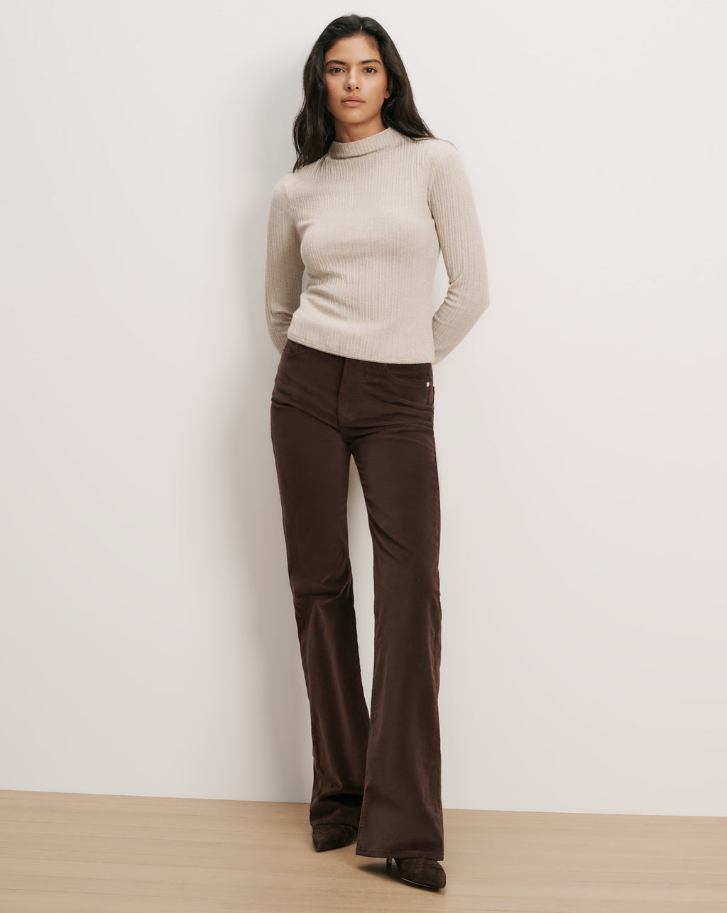 Veronica Beard Beige ribbed mock neck sweater and brown corduroy pants.