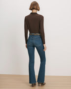 Veronica Beard Brown long-sleeve top, blue flare jeans, zebra belt