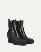 Veronica Beard Black patent leather and rubber heeled boots.