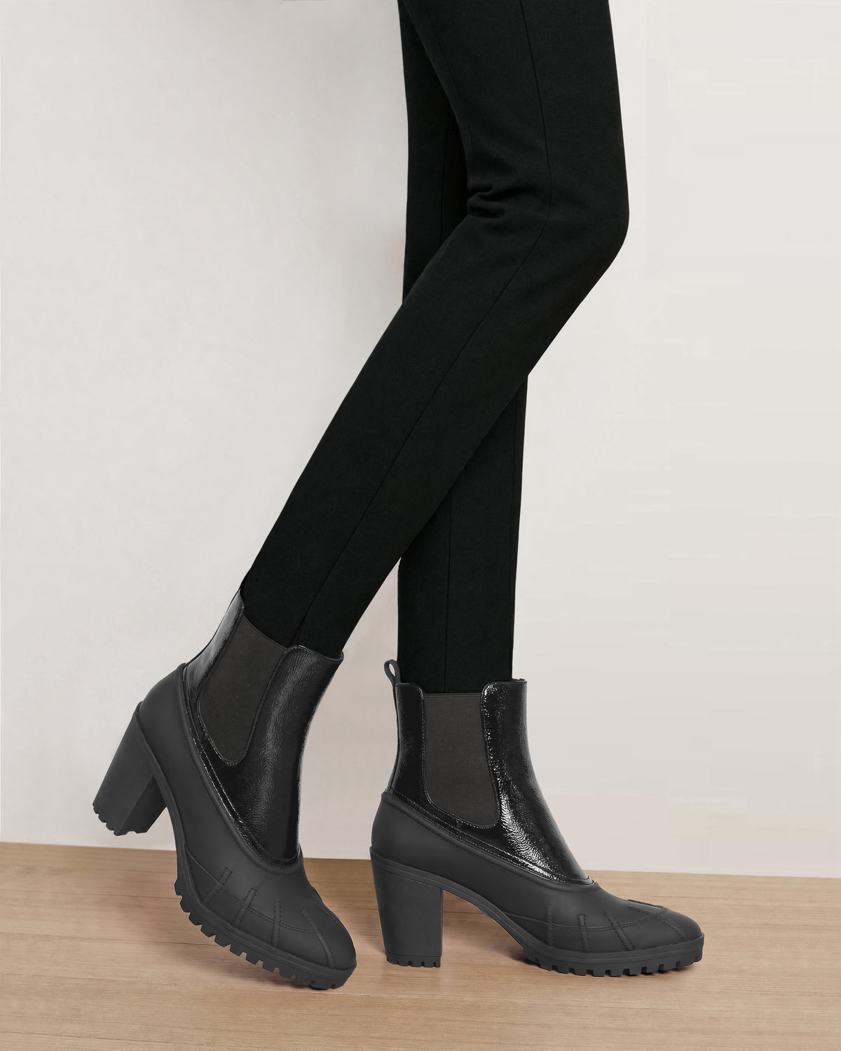 Veronica Beard Black patent leather heeled lug sole boots.