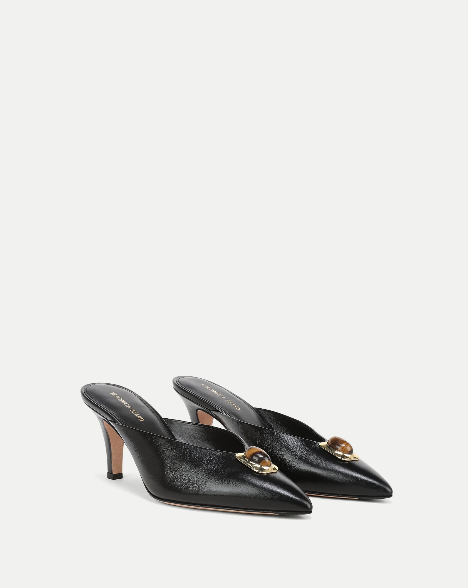 Veronica Beard Black leather mules with pointed toe and tiger's eye embellishment.