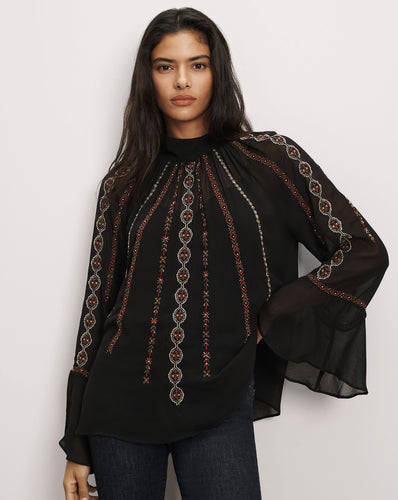 Veronica Beard Black sheer blouse with intricate red embroidery.