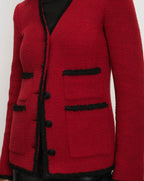 Veronica Beard Red tweed cardigan with black fringe trim.