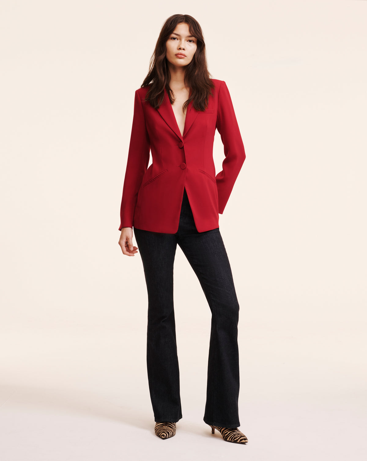 Veronica Beard Red blazer and dark flared jeans.