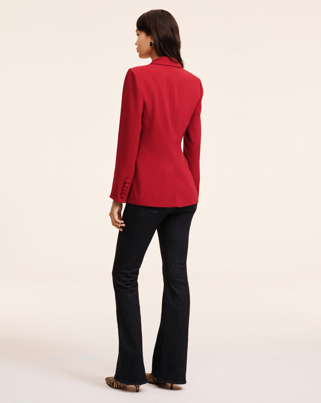 Veronica Beard Red tailored blazer and dark flare jeans.
