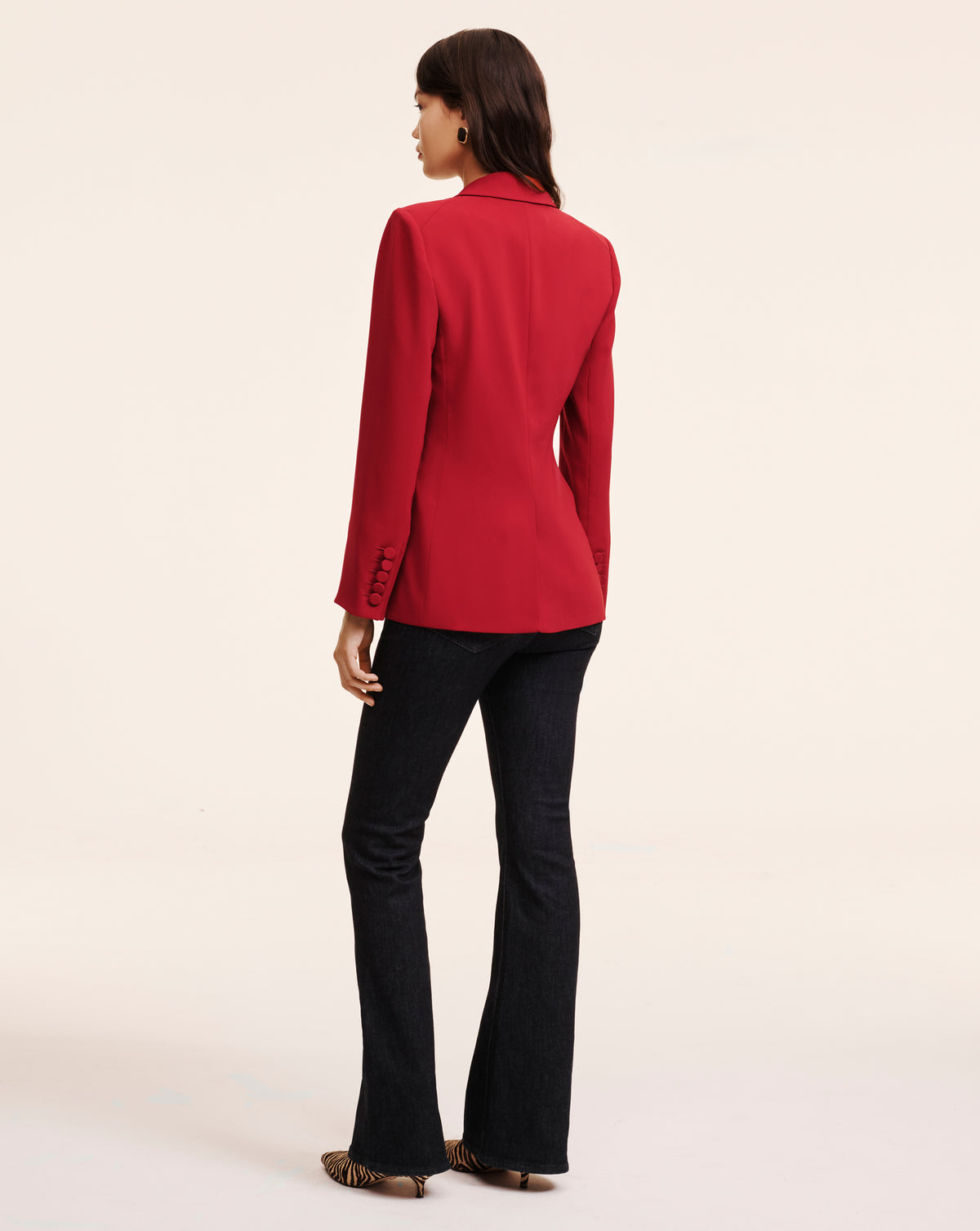 Veronica Beard Red tailored blazer and dark flare jeans.
