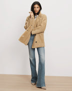 Veronica Beard Tan shearling jacket and blue flare jeans.