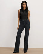 Veronica Beard Black satin sleeveless cowl-neck top and dark embellished jeans.
