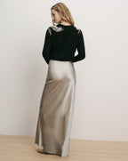 Veronica Beard Black sweater and metallic silver silk maxi skirt.