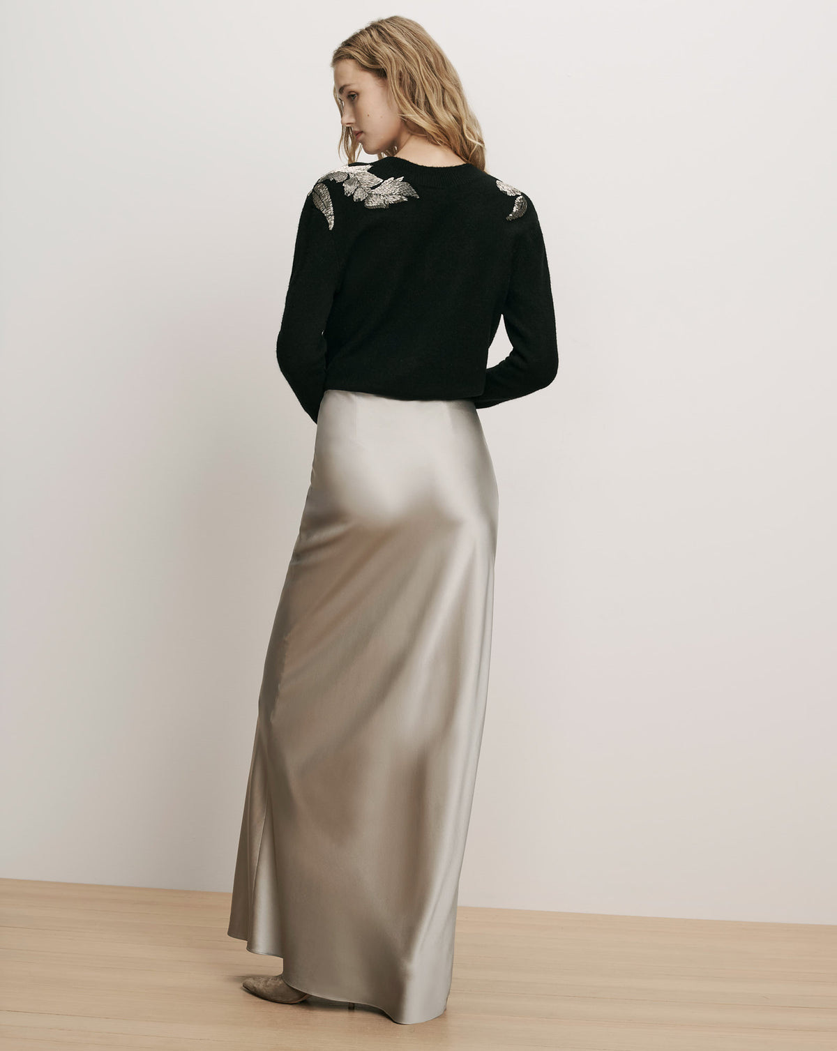 Veronica Beard Black sweater and metallic silver silk maxi skirt.