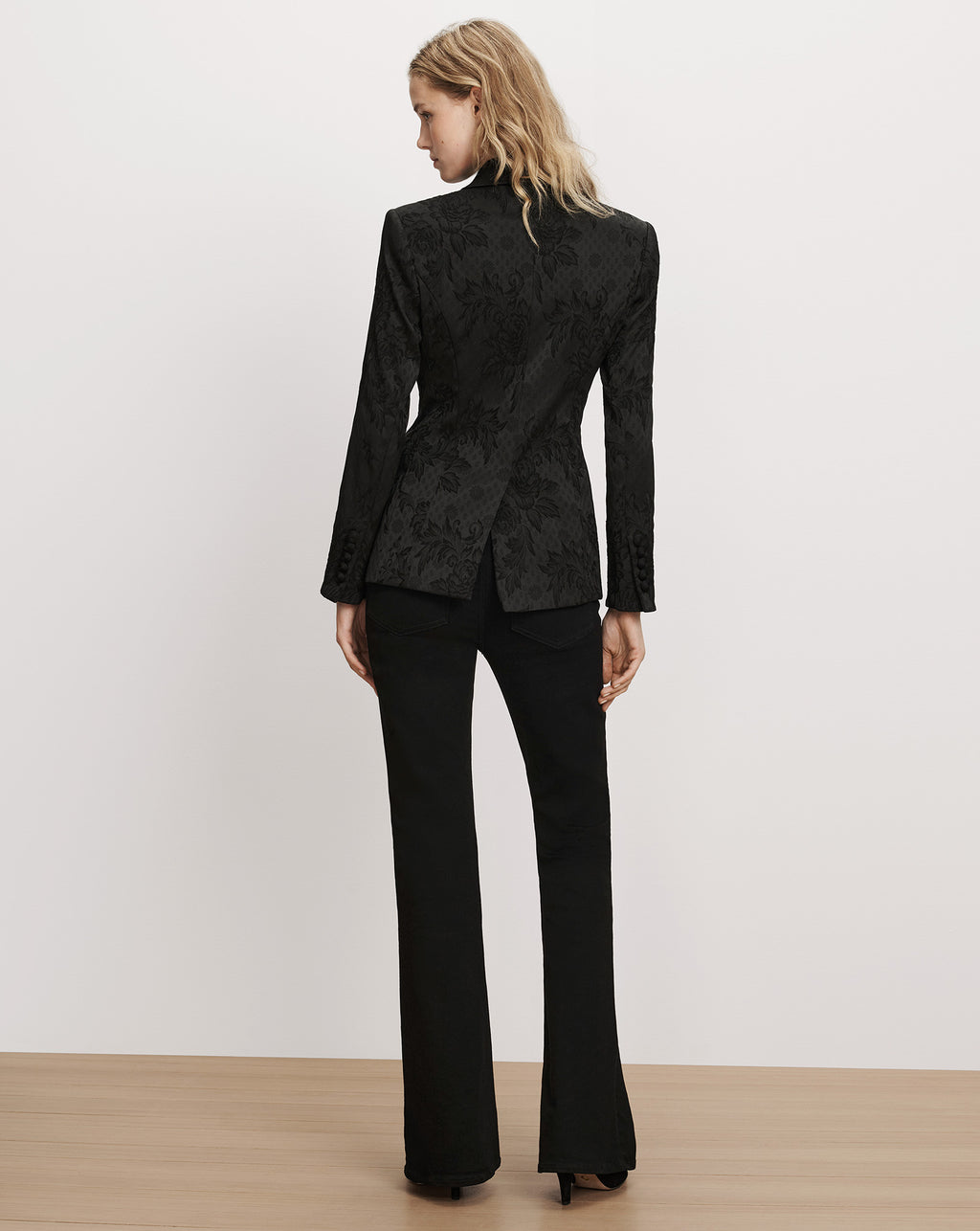 Veronica Beard Black floral brocade blazer and black trousers.