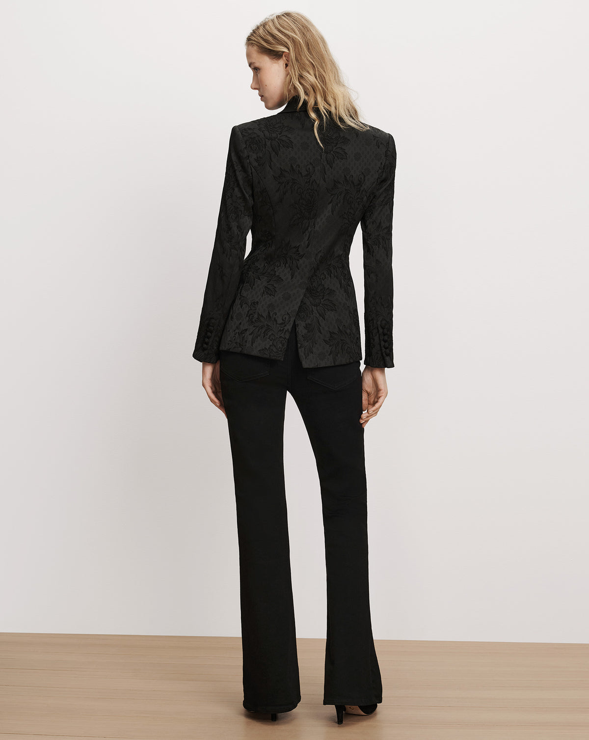 Veronica Beard Black floral brocade blazer and black trousers.