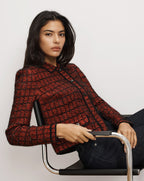 Veronica Beard Red tweed cropped jacket with black trim.