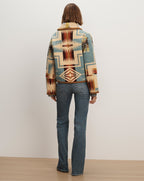 Veronica Beard Multicolor patterned wool crop jacket and blue jeans.