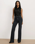 Veronica Beard Black sleeveless satin top and dark denim jeans.