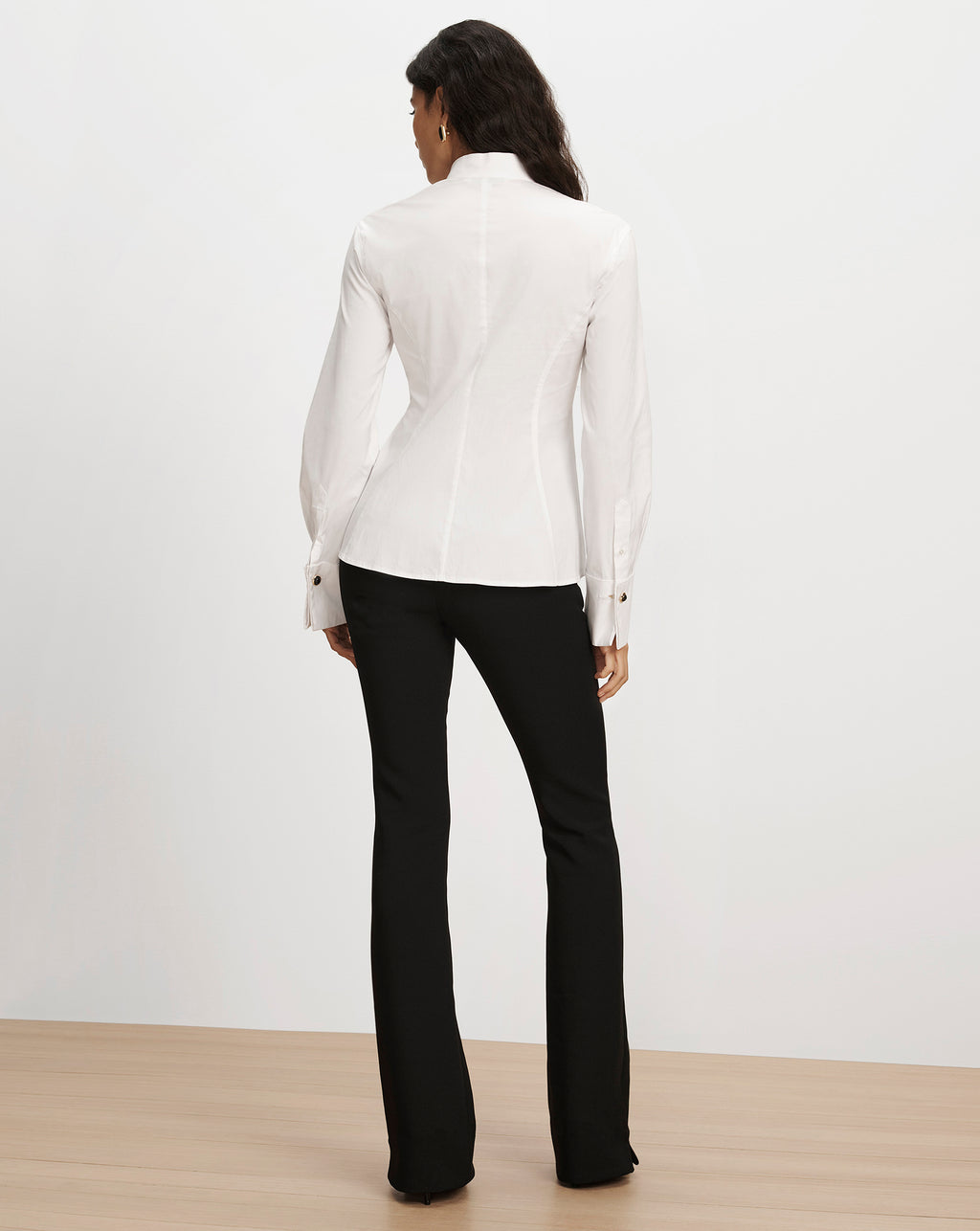 Veronica Beard White fitted button-down shirt and black trousers.