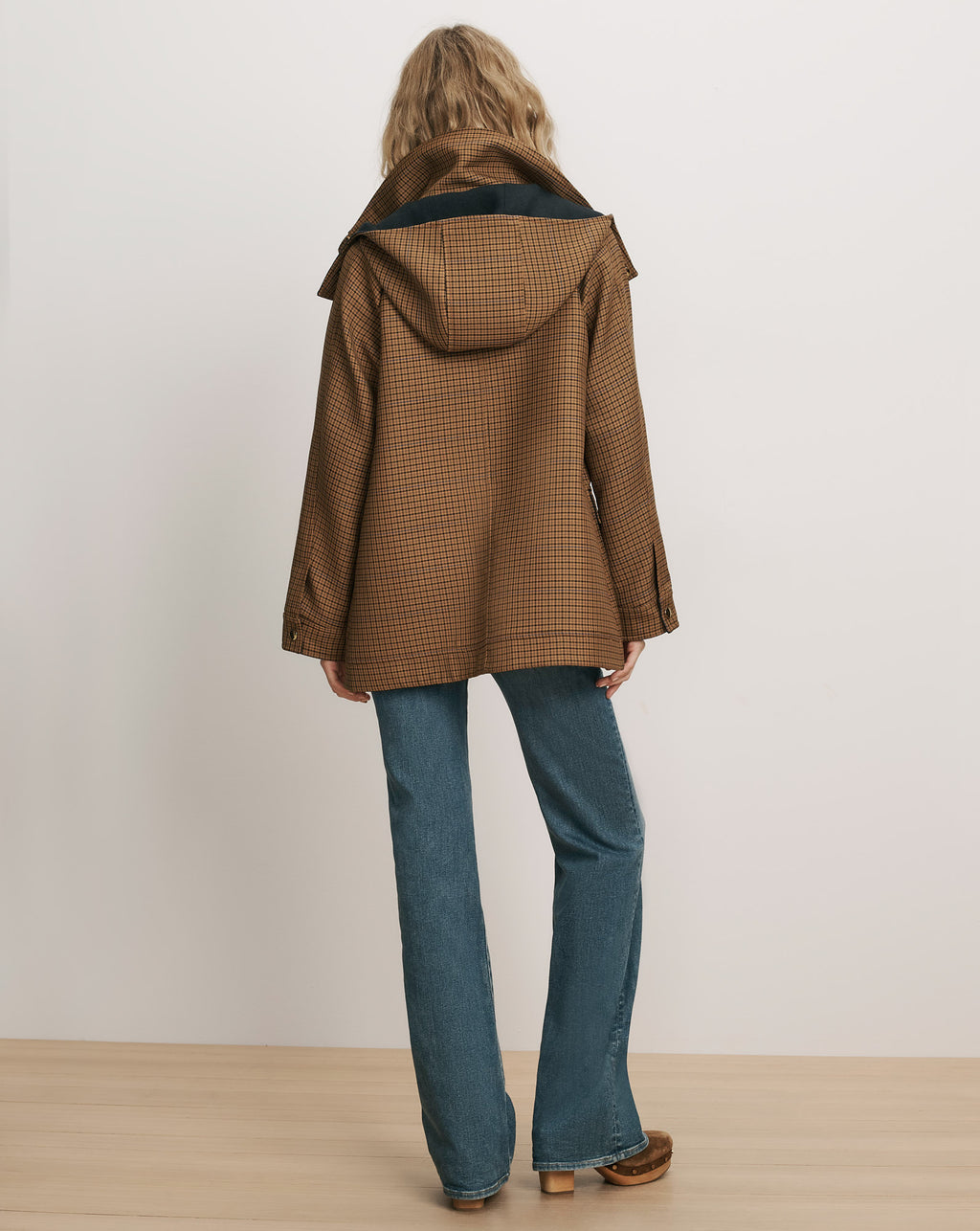 Veronica Beard Brown plaid hooded coat and blue denim jeans.