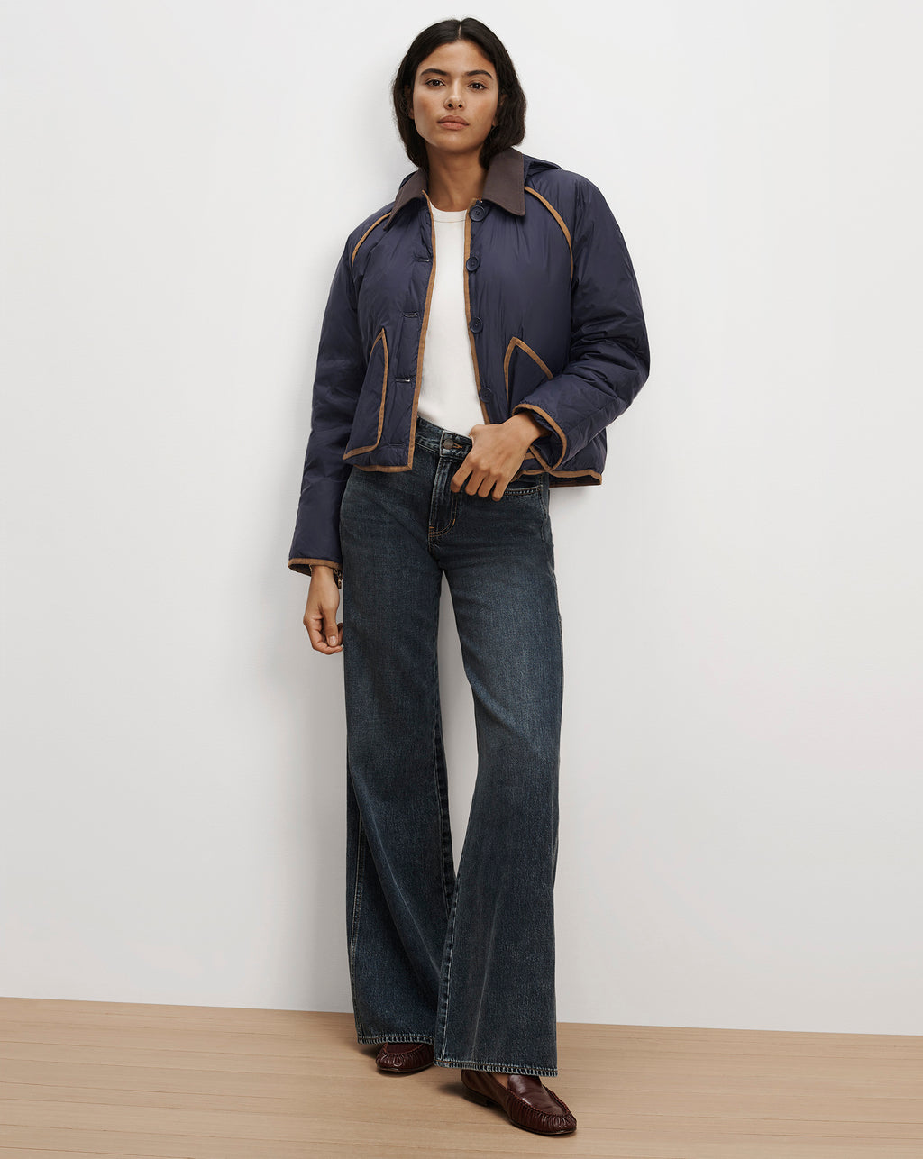 Veronica Beard Navy quilted jacket with brown trim and jeans.