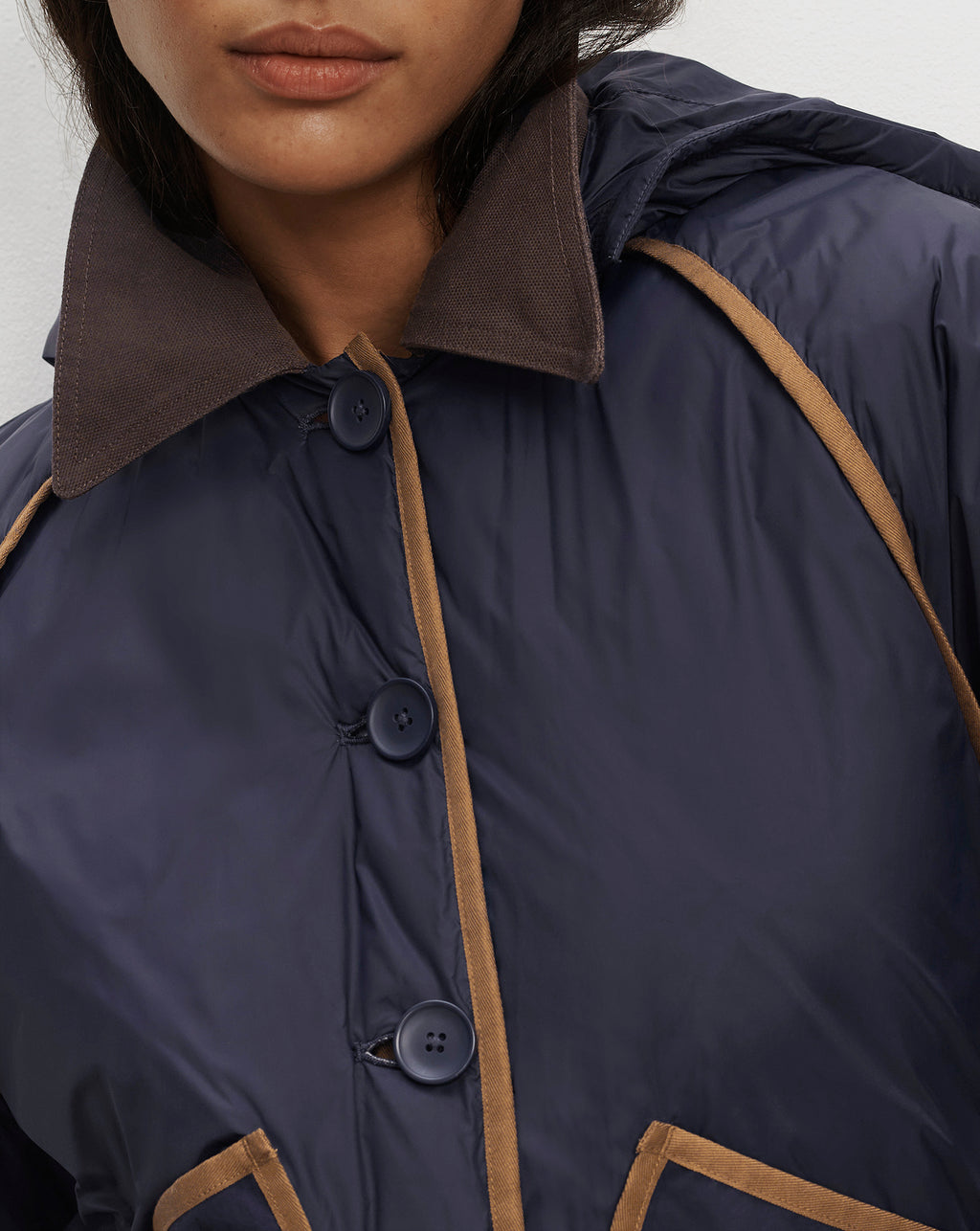 Veronica Beard Navy blue quilted jacket with brown trim.