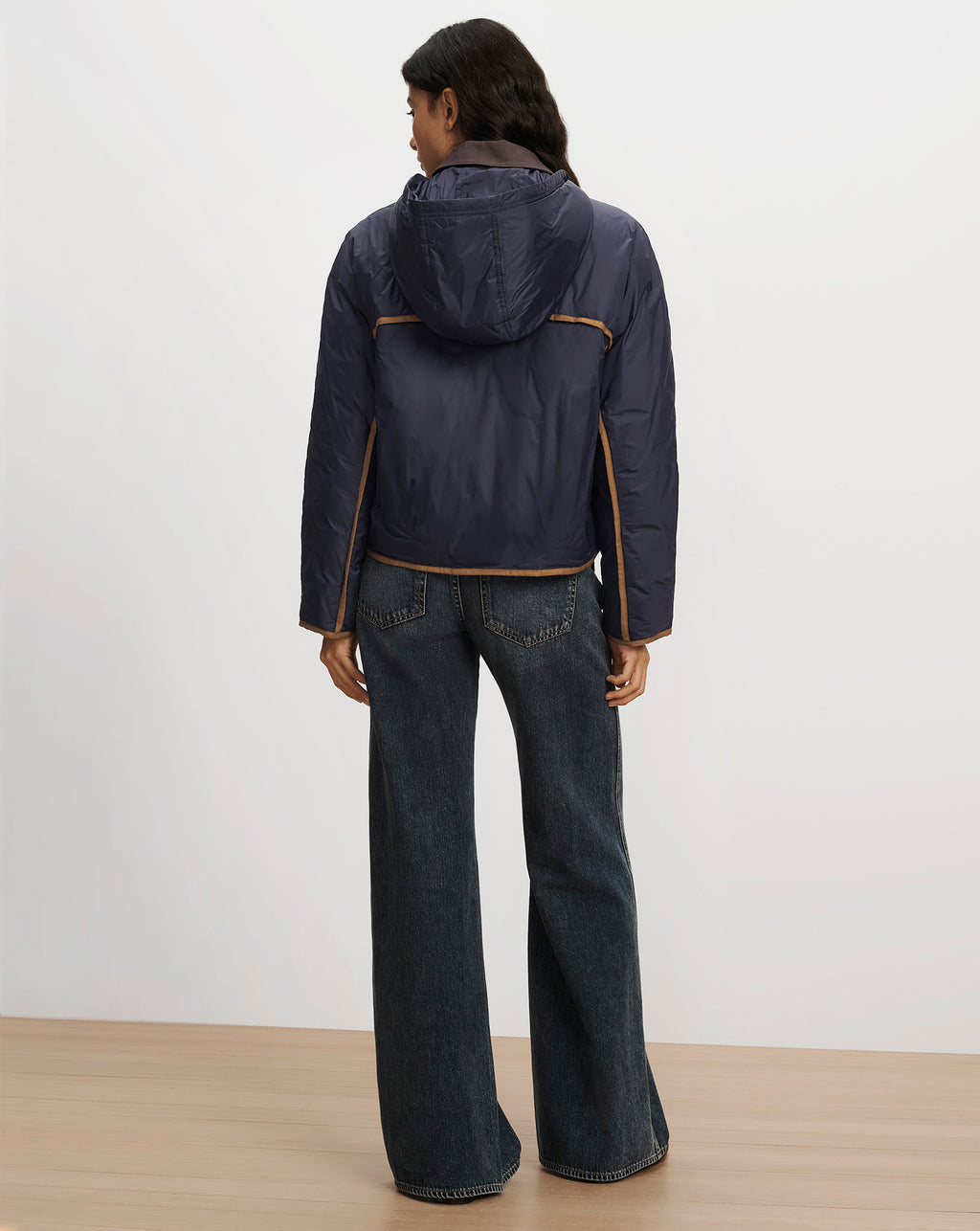Veronica Beard Navy hooded puffer jacket with brown piping.