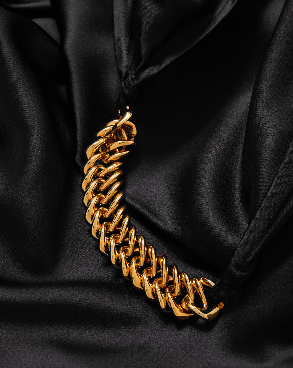 Veronica Beard Black satin garment with thick gold chain detail.