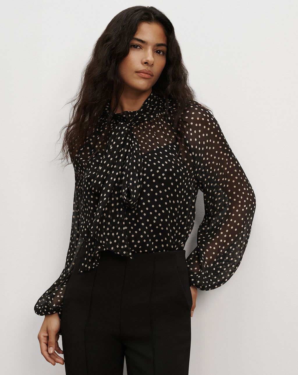 Veronica Beard Sheer black polka dot tie-neck blouse.