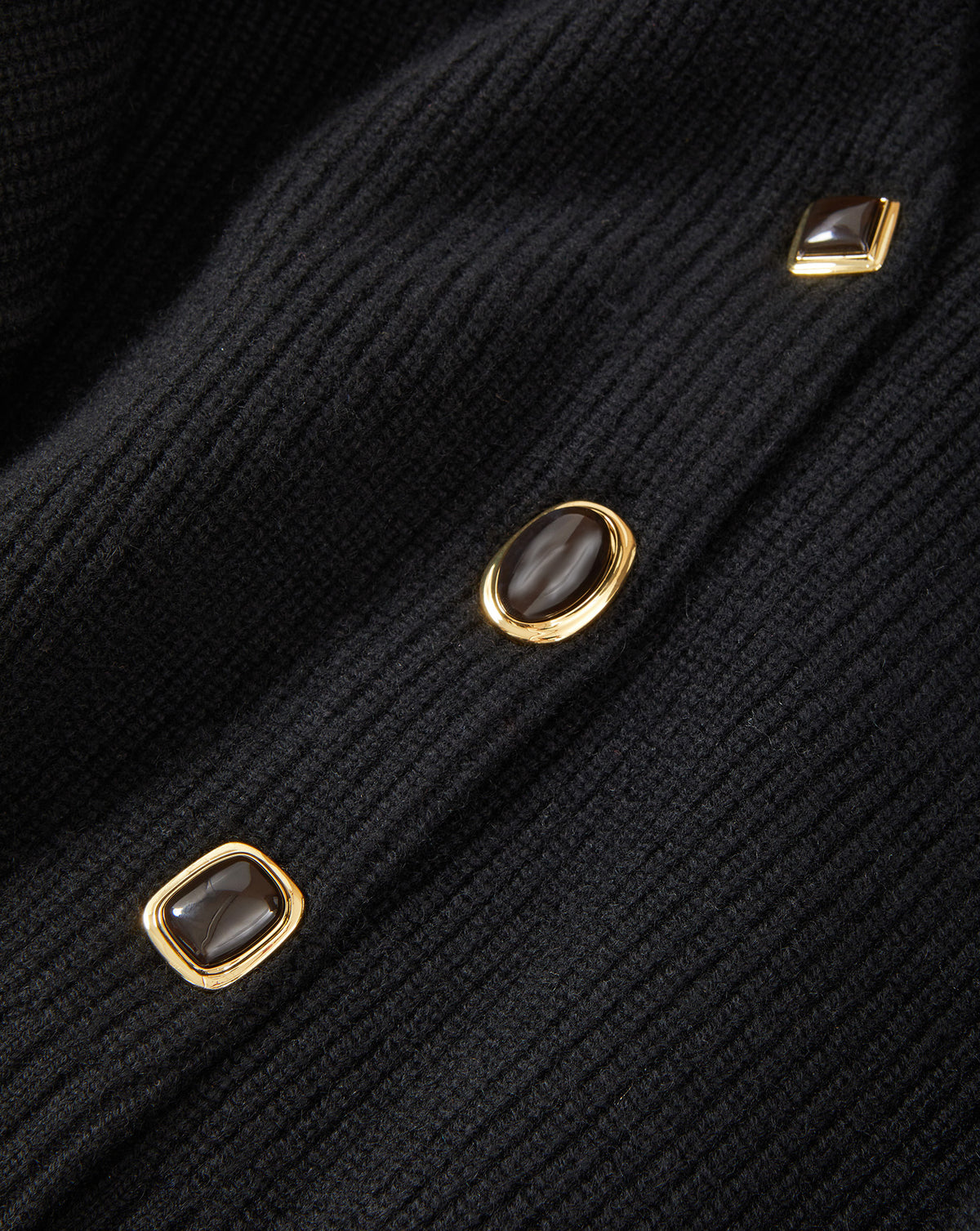 Veronica Beard Black ribbed cardigan with gold-rimmed buttons.