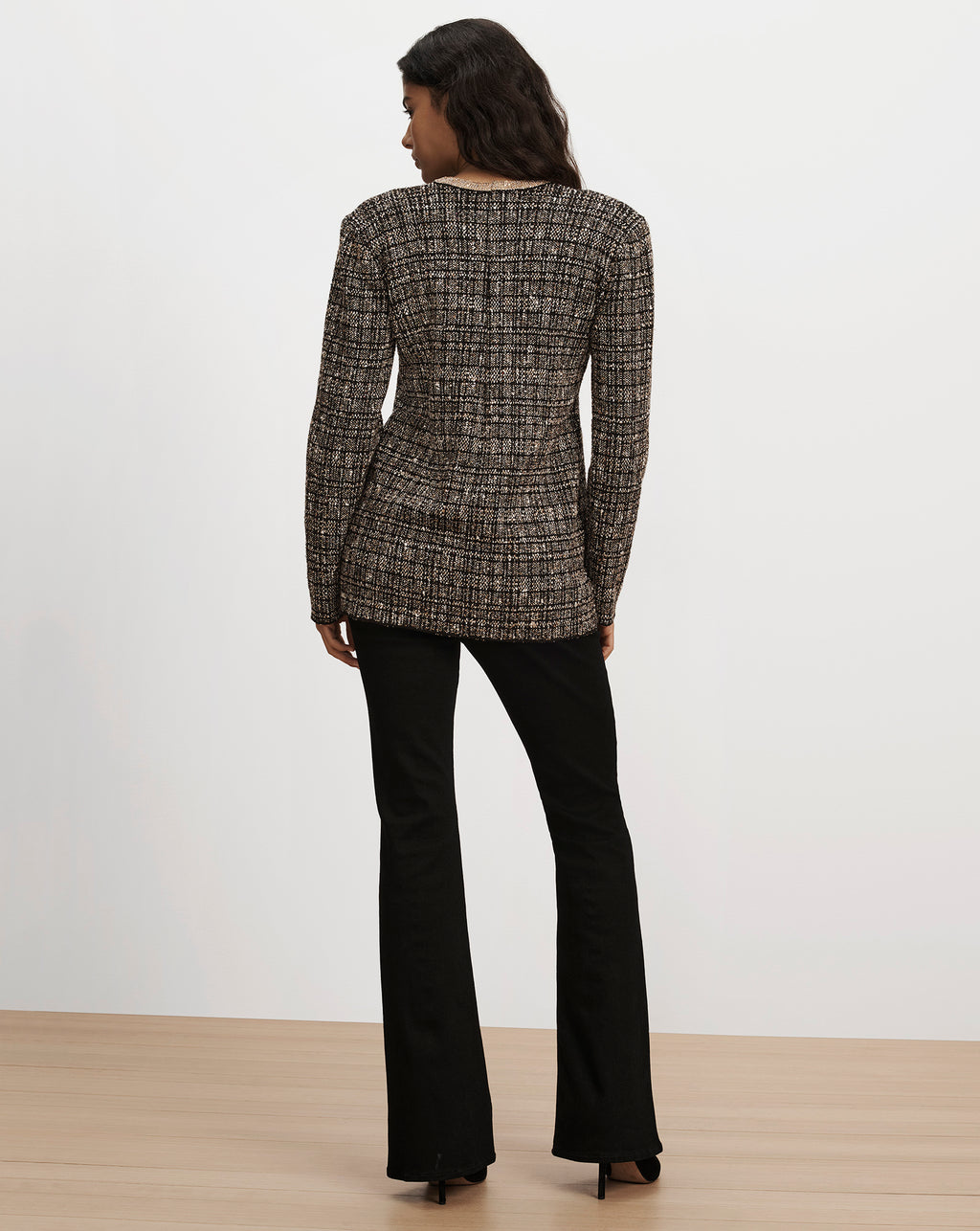 Veronica Beard Brown tweed blazer and black flare trousers.