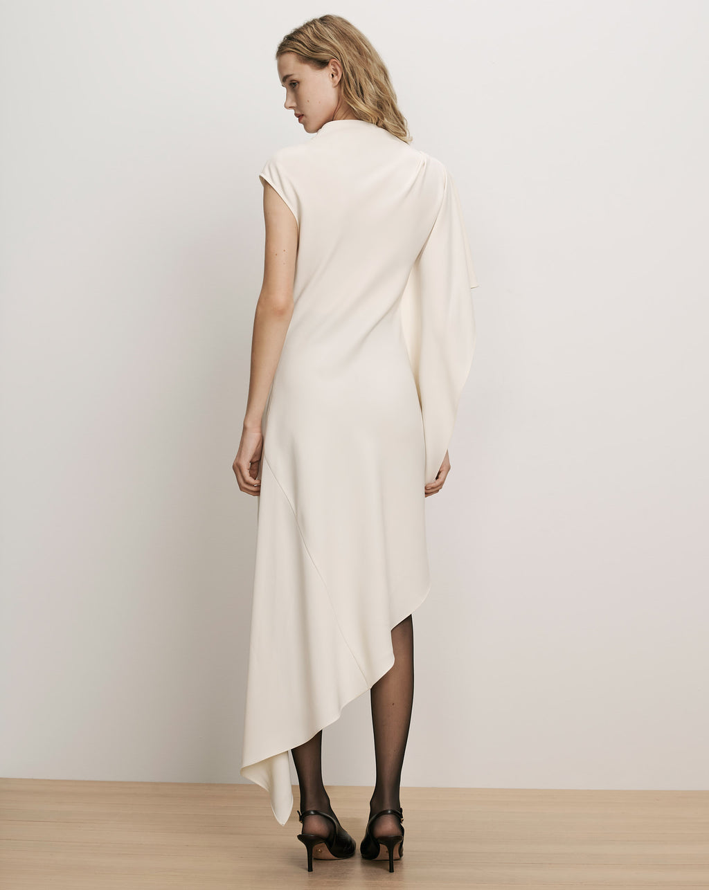 Veronica Beard White asymmetric dress with draped sleeve detail.