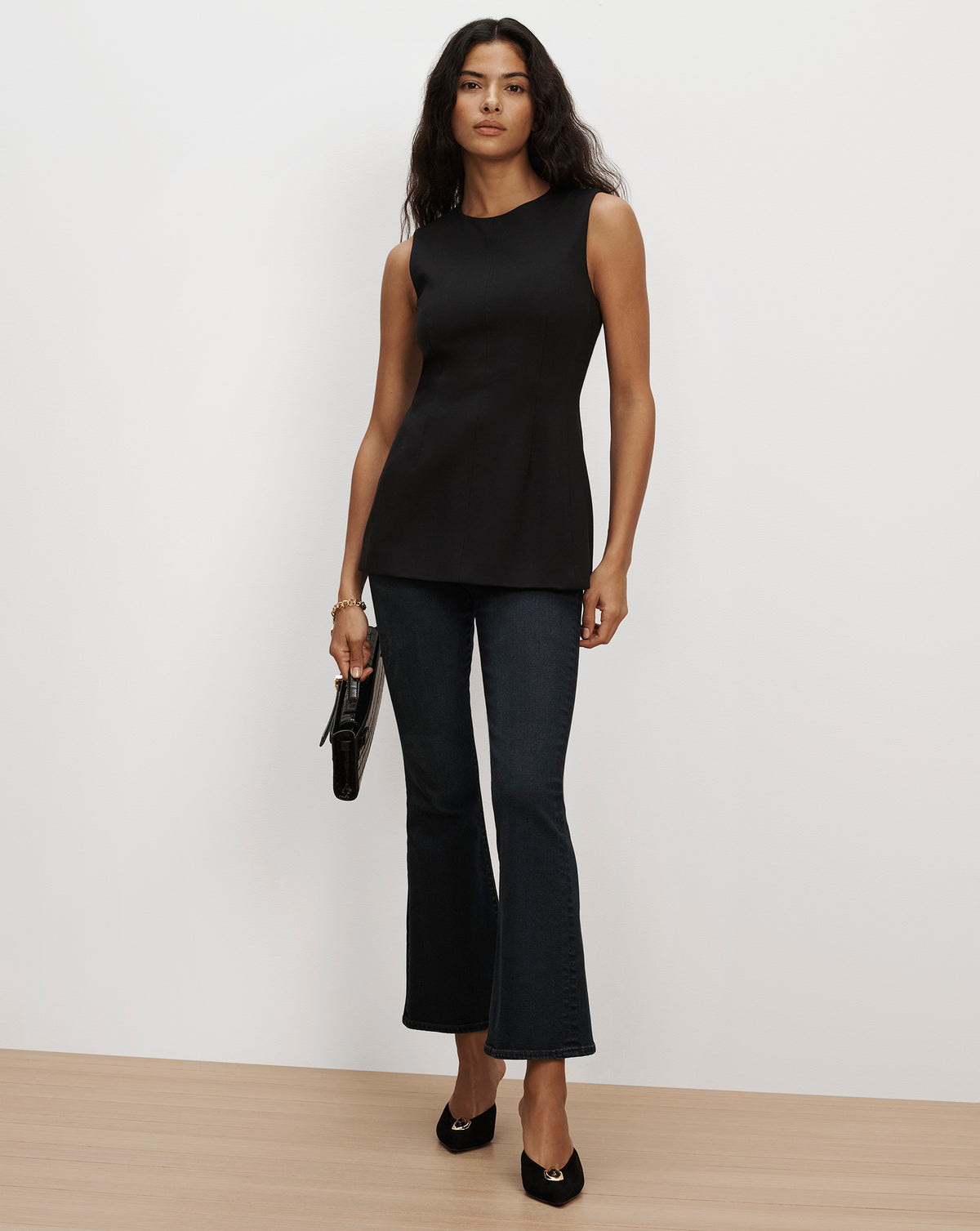 Veronica Beard Black sleeveless top and dark denim flare jeans.