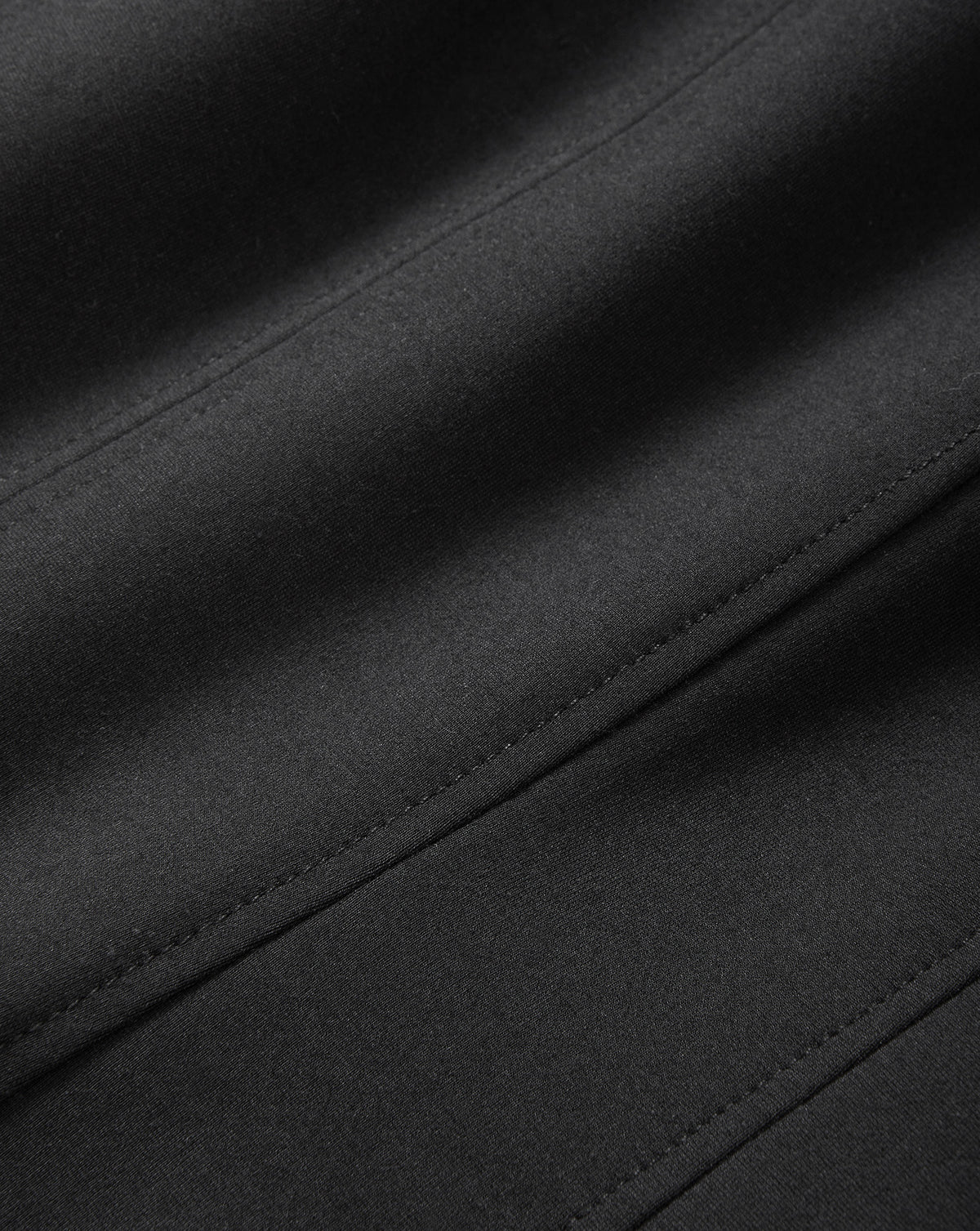 Veronica Beard Black fabric with smooth texture and stitched seams.