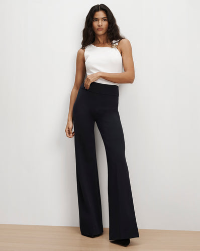 Veronica Beard Black high-waisted wide-leg trousers and white top.