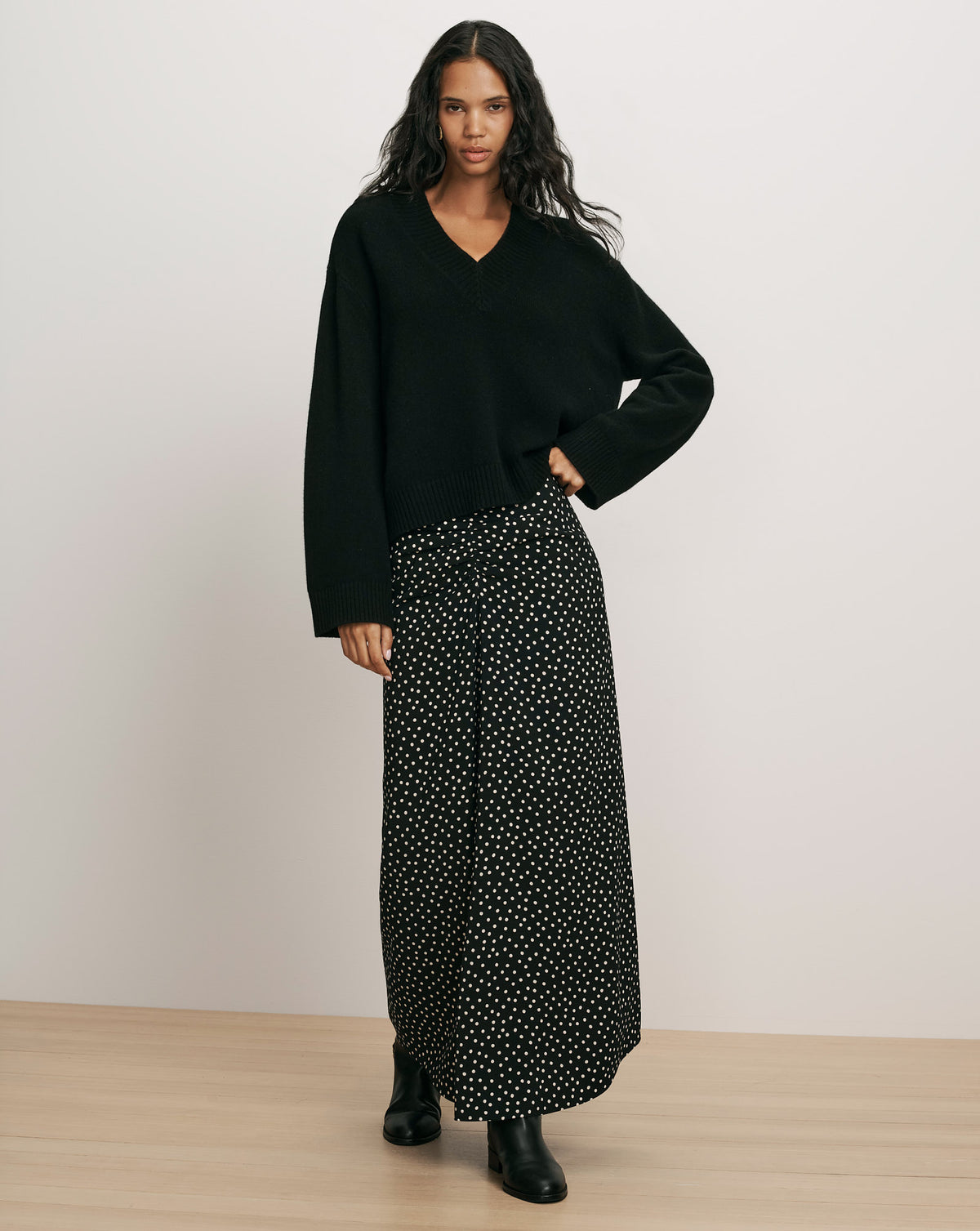 Veronica Beard Black v-neck knit sweater and polka dot skirt.