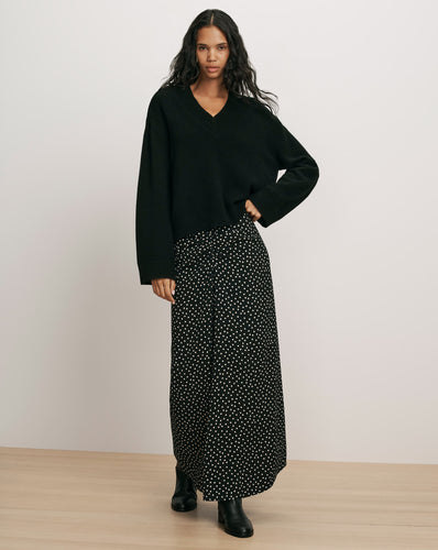 Veronica Beard Black v-neck knit sweater and polka dot skirt.