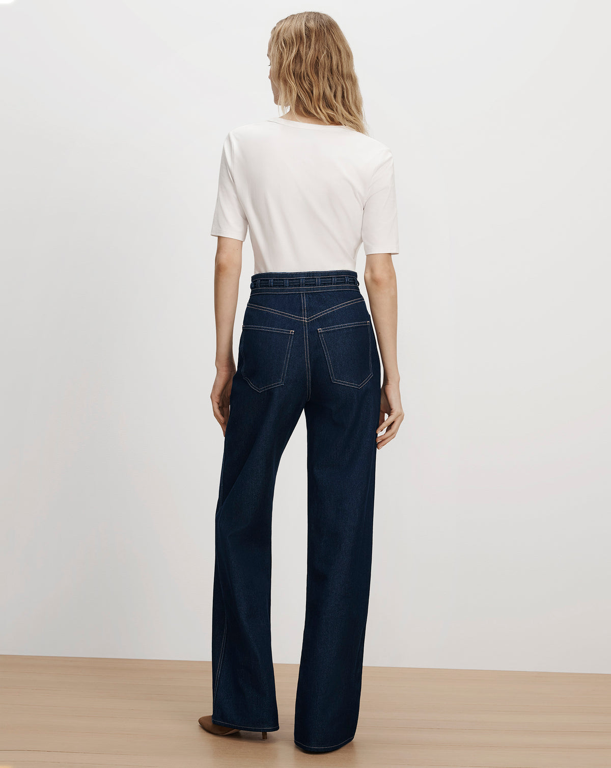 Veronica Beard White t-shirt and dark blue wide-leg jeans.
