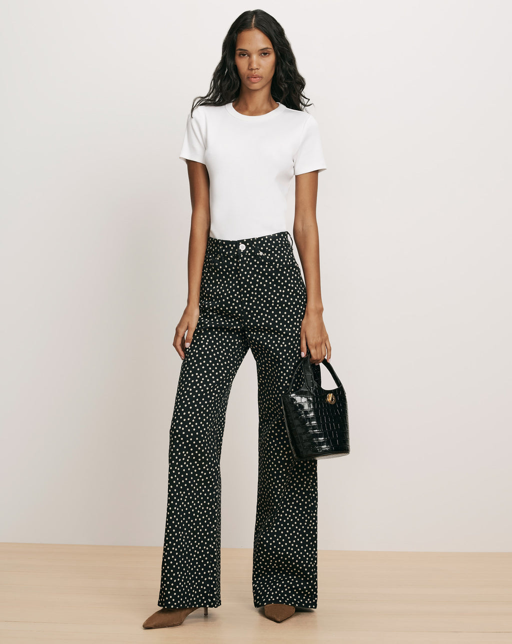 Veronica Beard White crewneck t-shirt and black polka-dot trousers.
