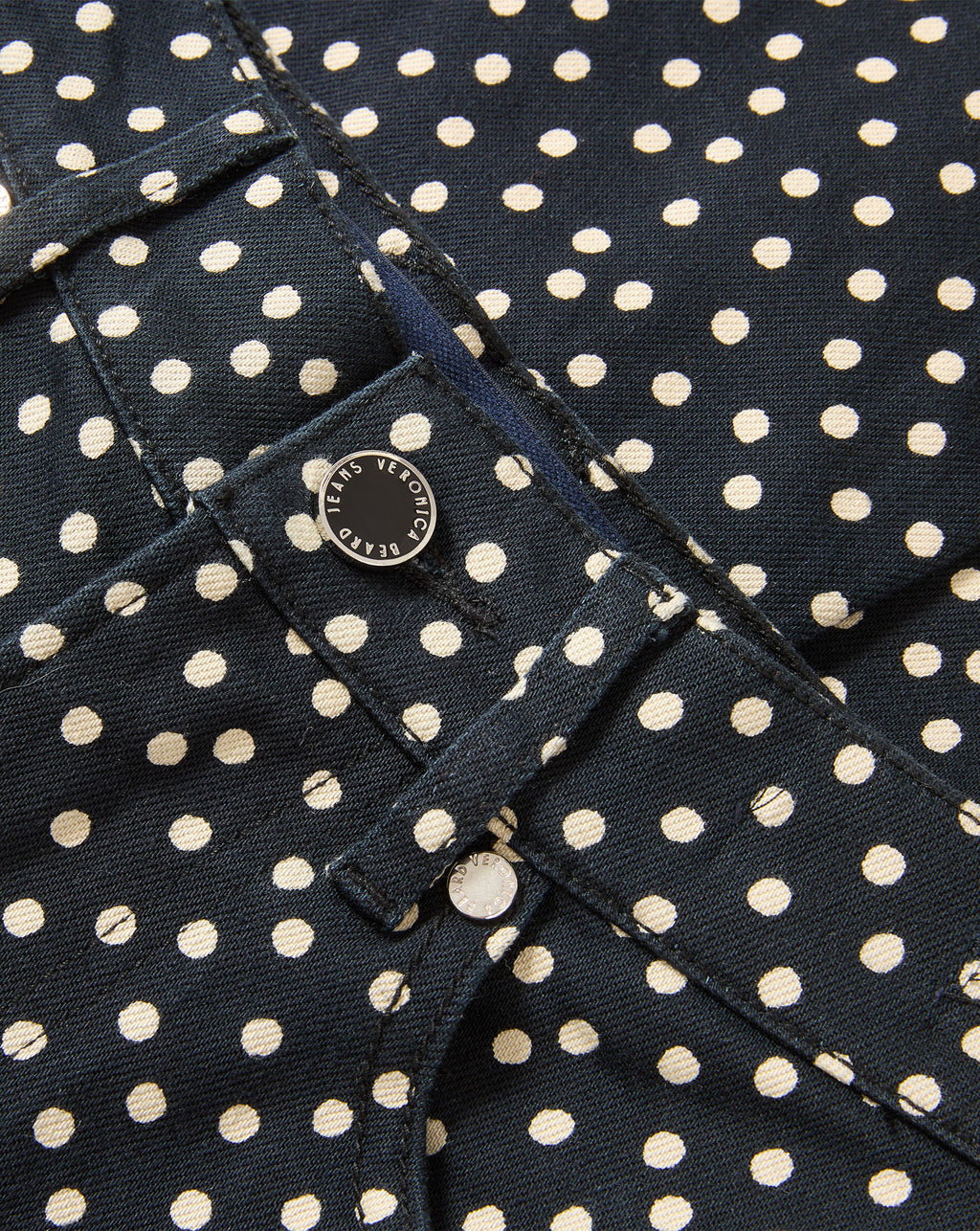 Veronica Beard Dark blue polka dot denim jeans with button closure.