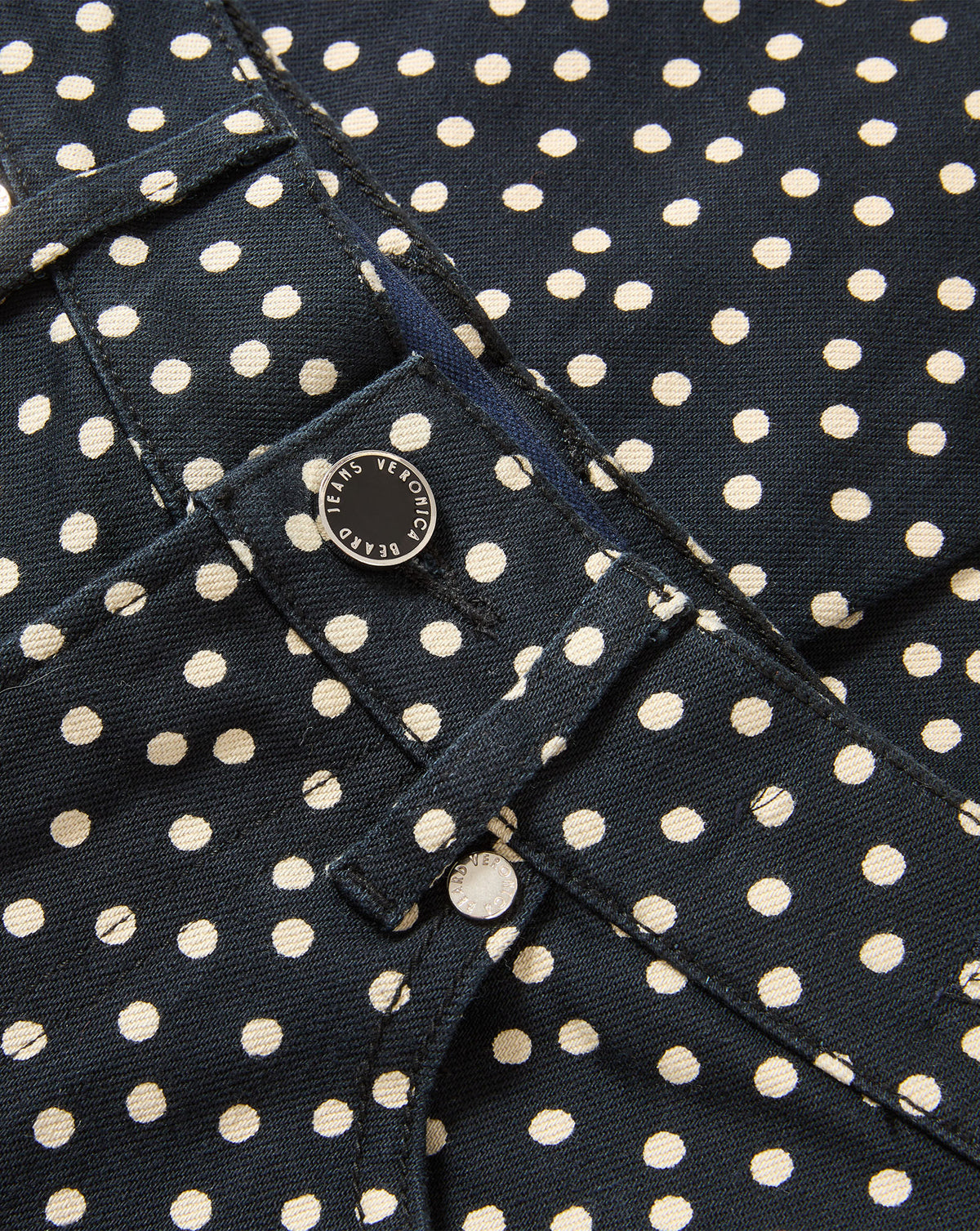 Veronica Beard Dark blue polka dot denim jeans with button closure.
