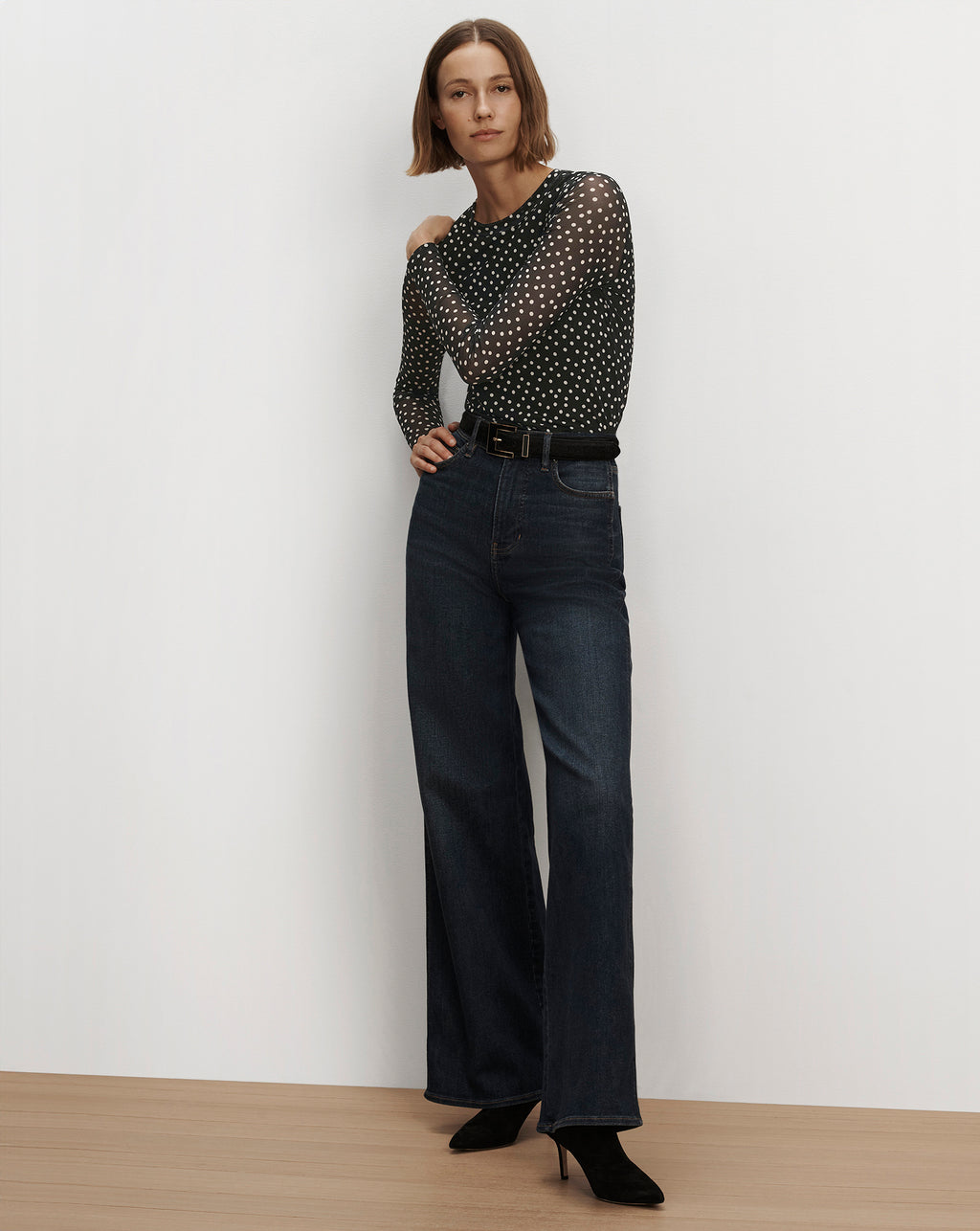 Veronica Beard Sheer black polka dot long sleeve top, wide leg jeans.