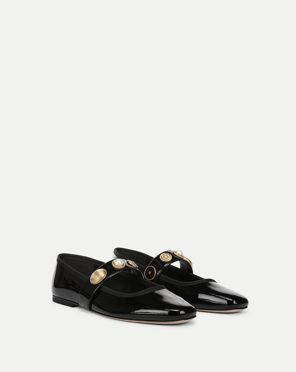 Veronica Beard Black patent leather flats with gold buttons.
