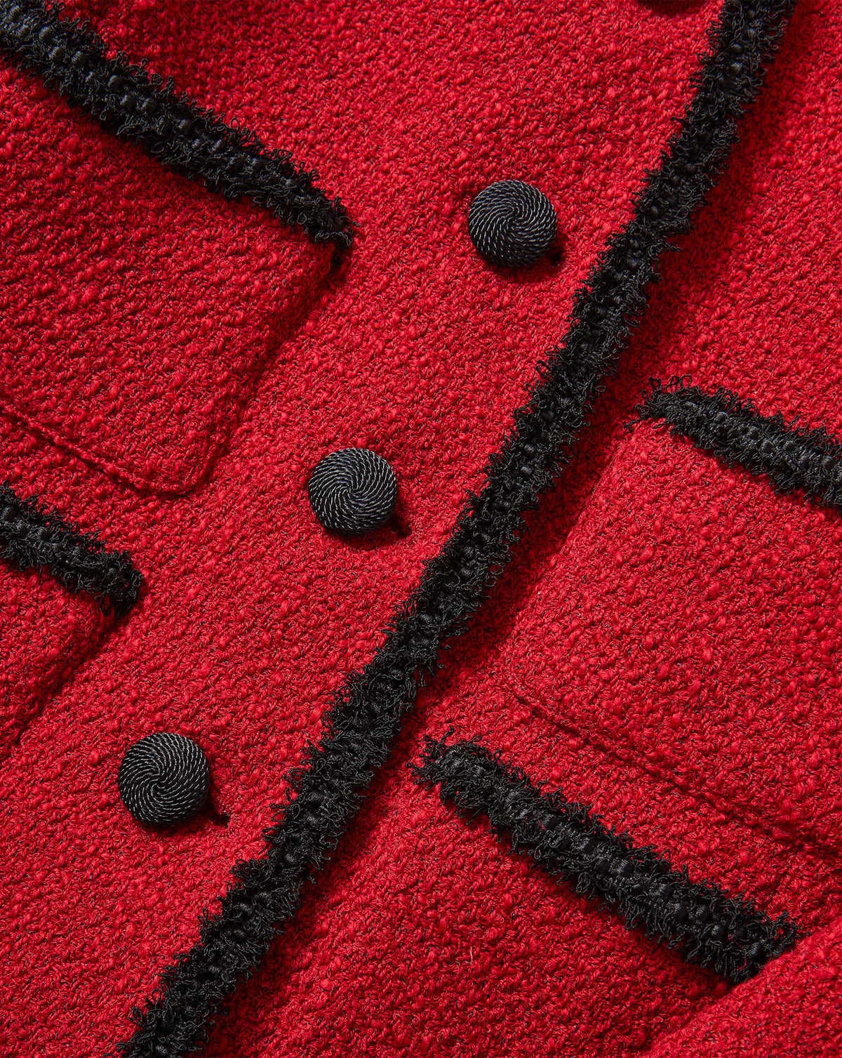Veronica Beard Red tweed jacket with black fringe trim and buttons.