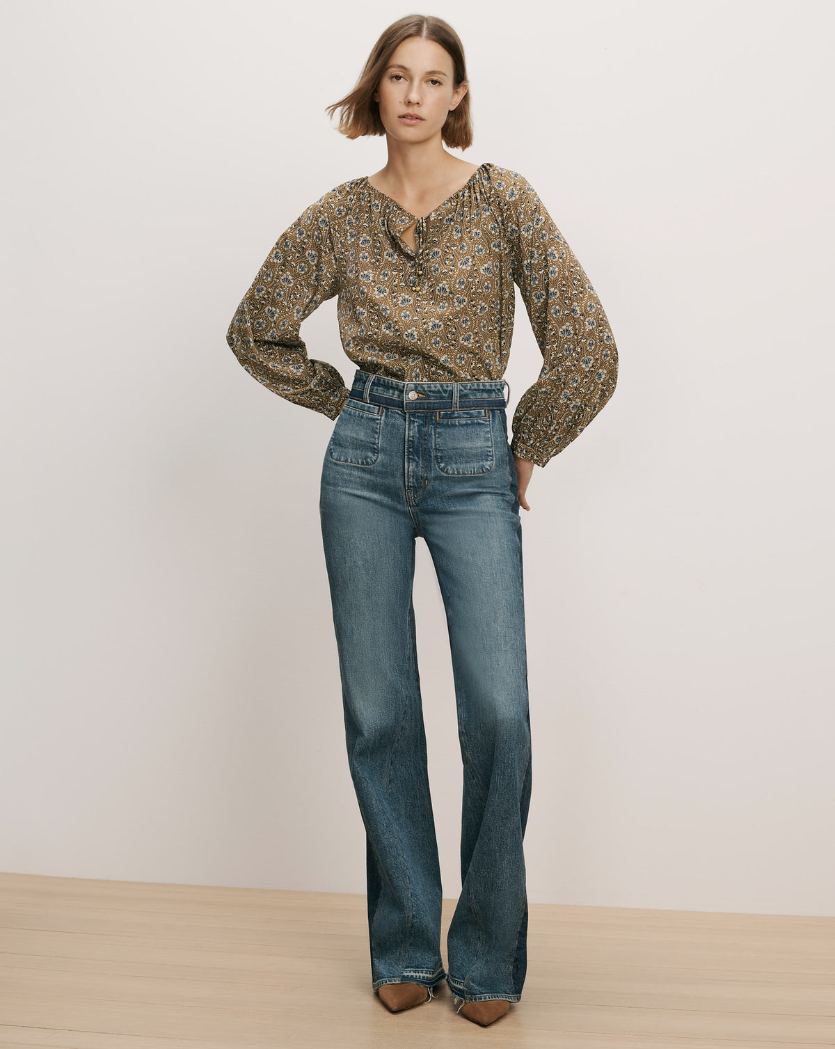 Veronica Beard Brown floral patterned long-sleeve blouse and blue jeans.