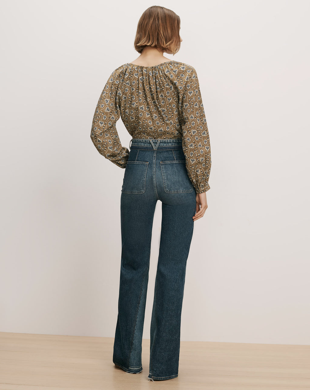 Veronica Beard Blue high-waisted denim jeans and patterned blouse.