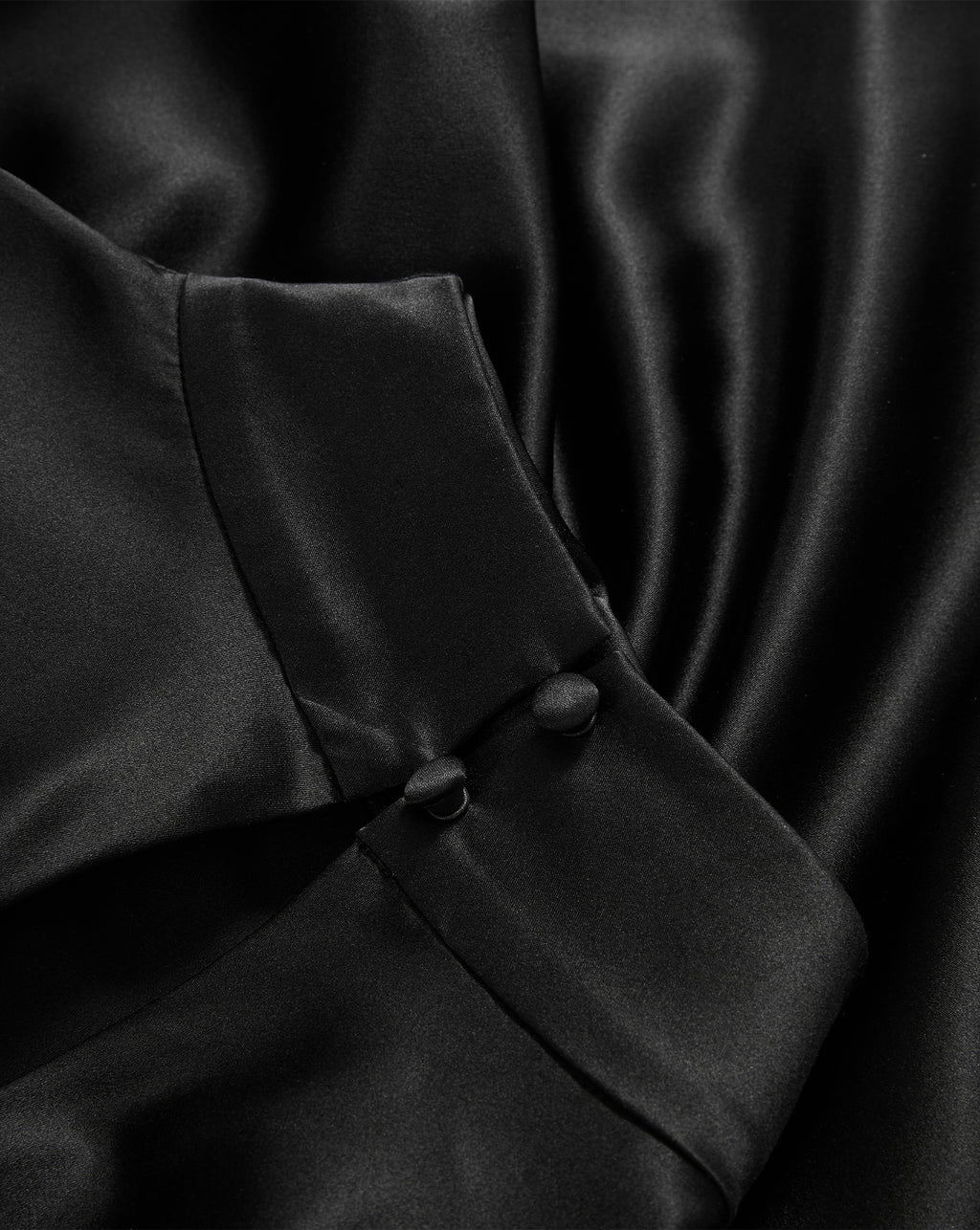 Veronica Beard Black silk blouse with covered button cuffs.
