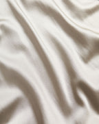 Veronica Beard Glossy silver satin fabric with soft folds.
