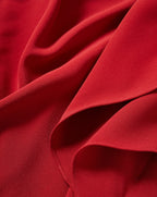 Veronica Beard Red woven fabric with draped silhouette and texture.